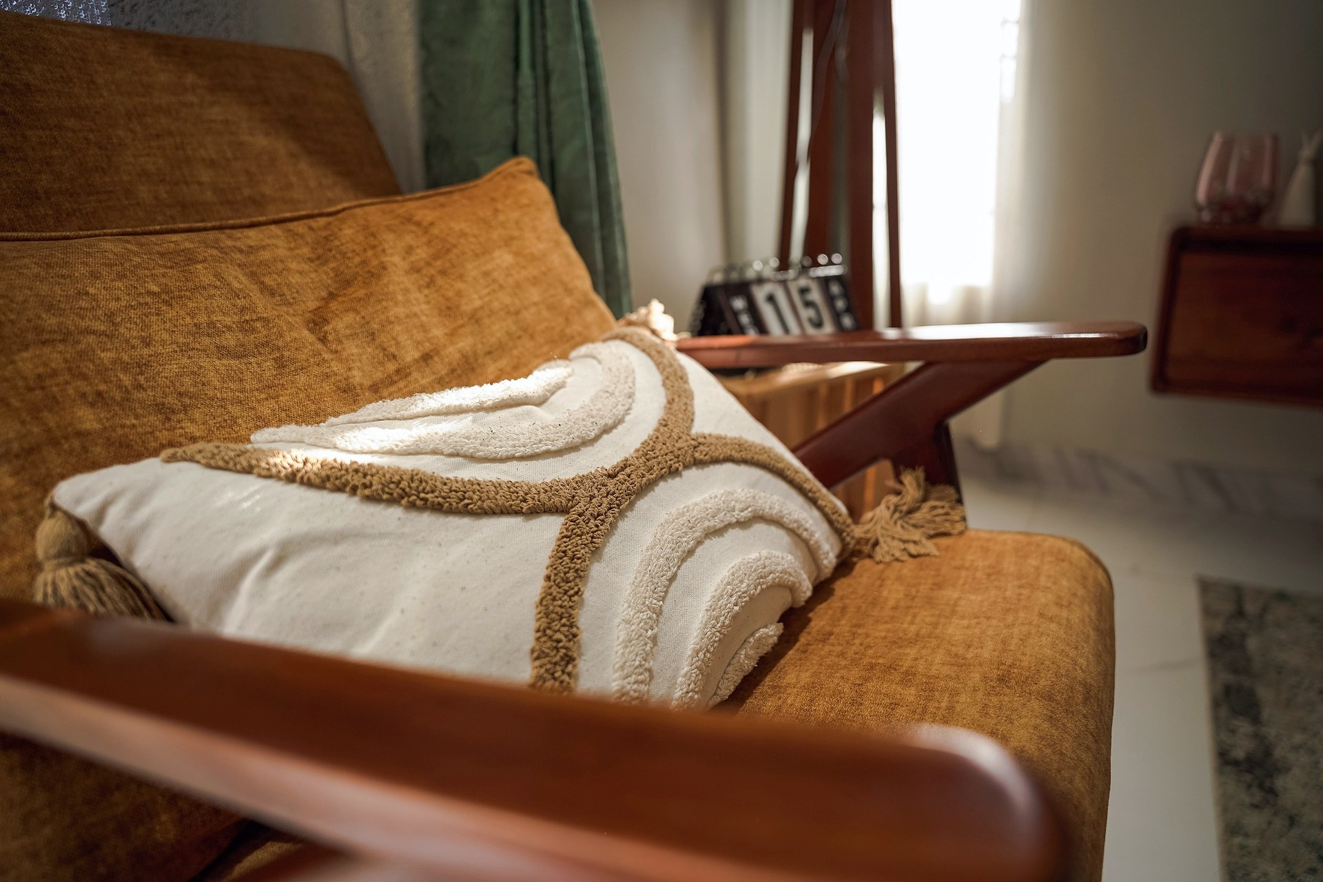 A rust chair with a cream cushion stitched with arcs