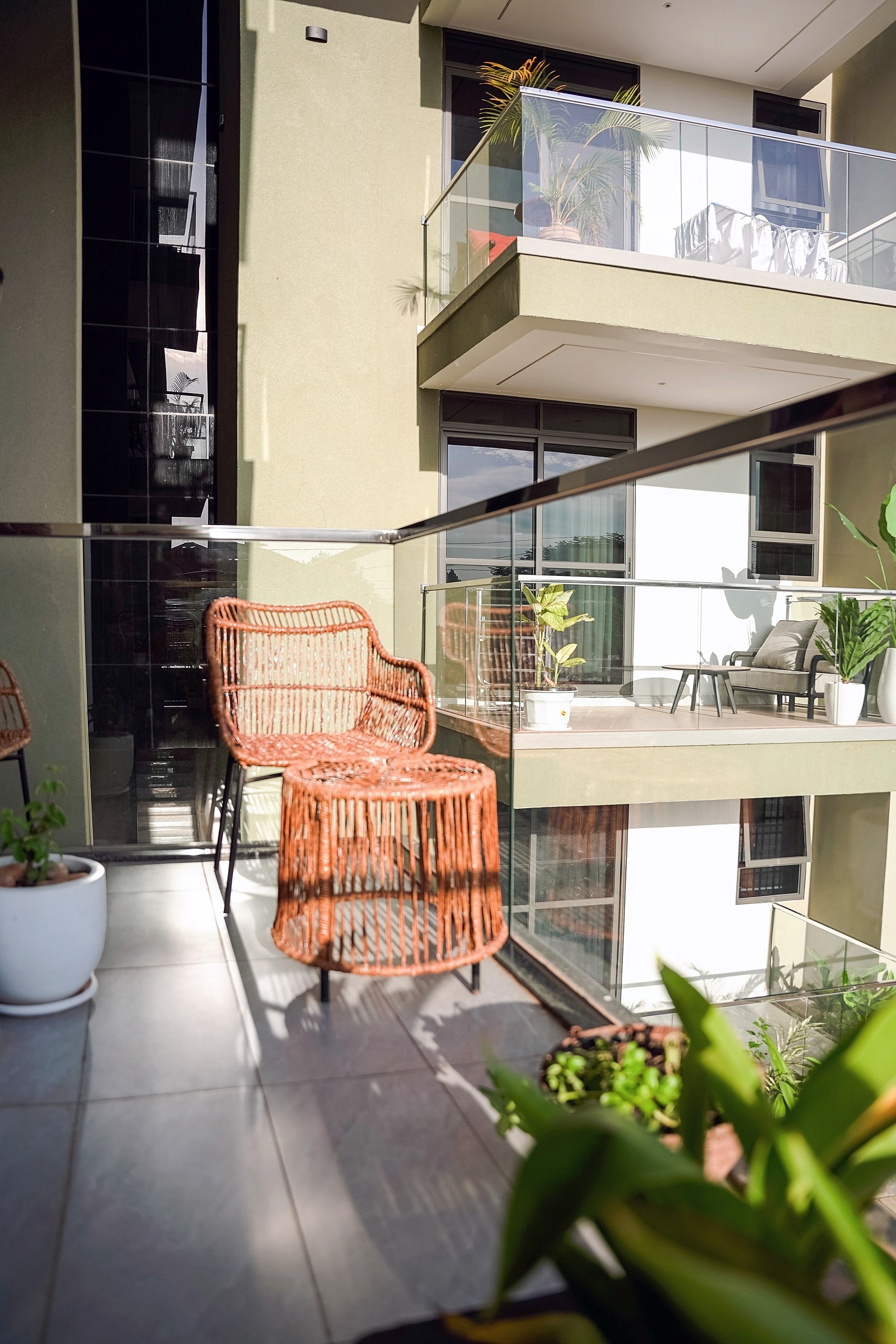 Potted plants along the balcony edge in afternoon light