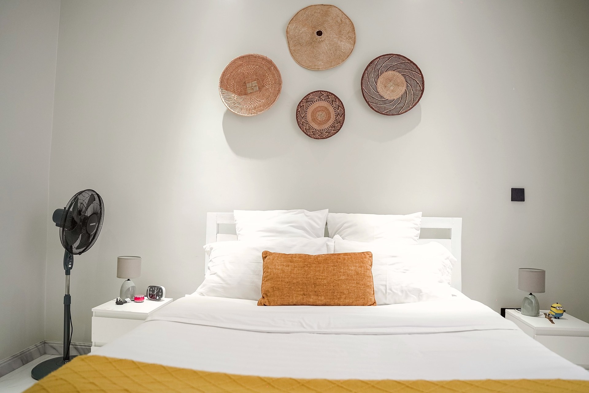 The bedroom by day under woven baskets