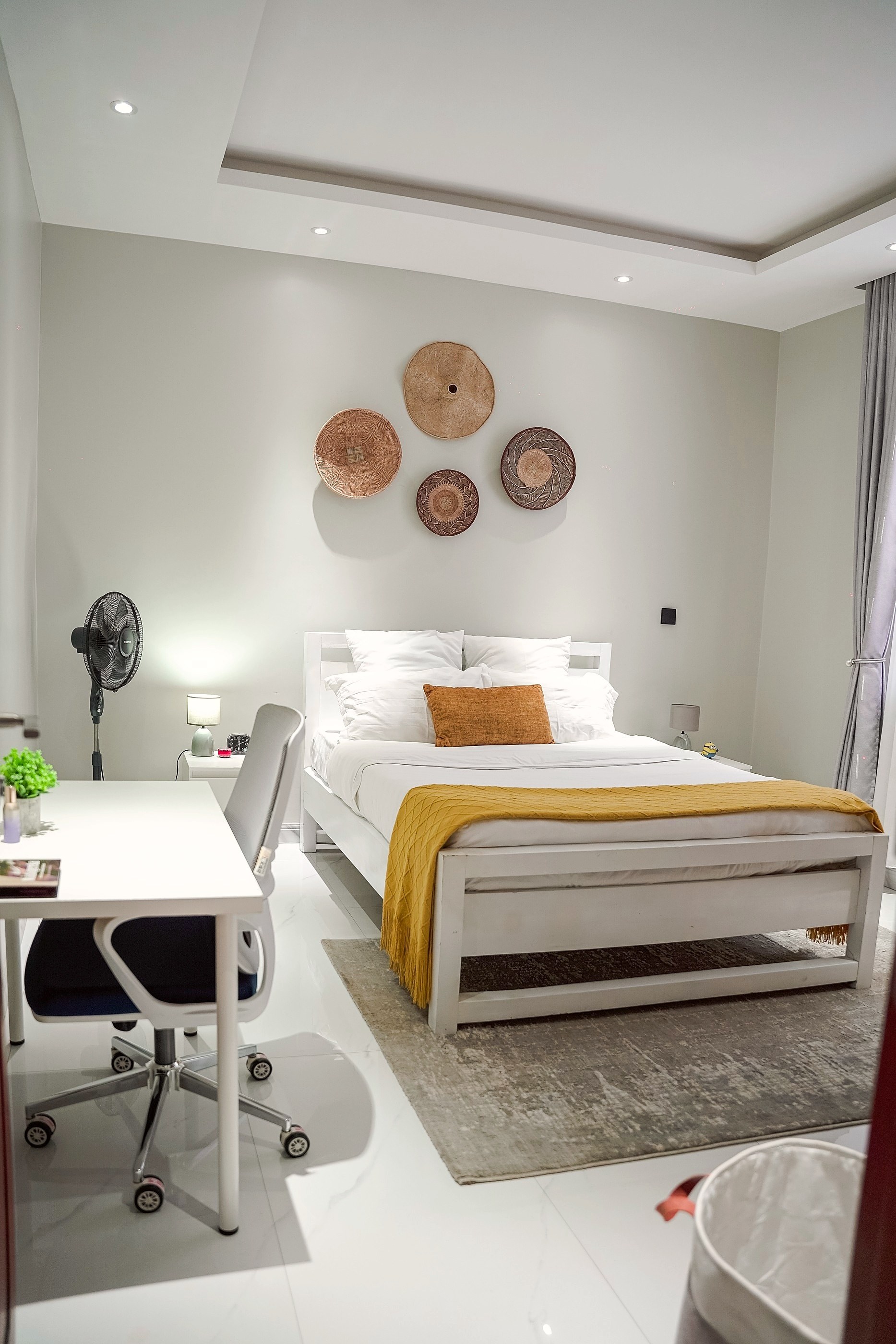 The bedroom seen past the open door, the desk in front