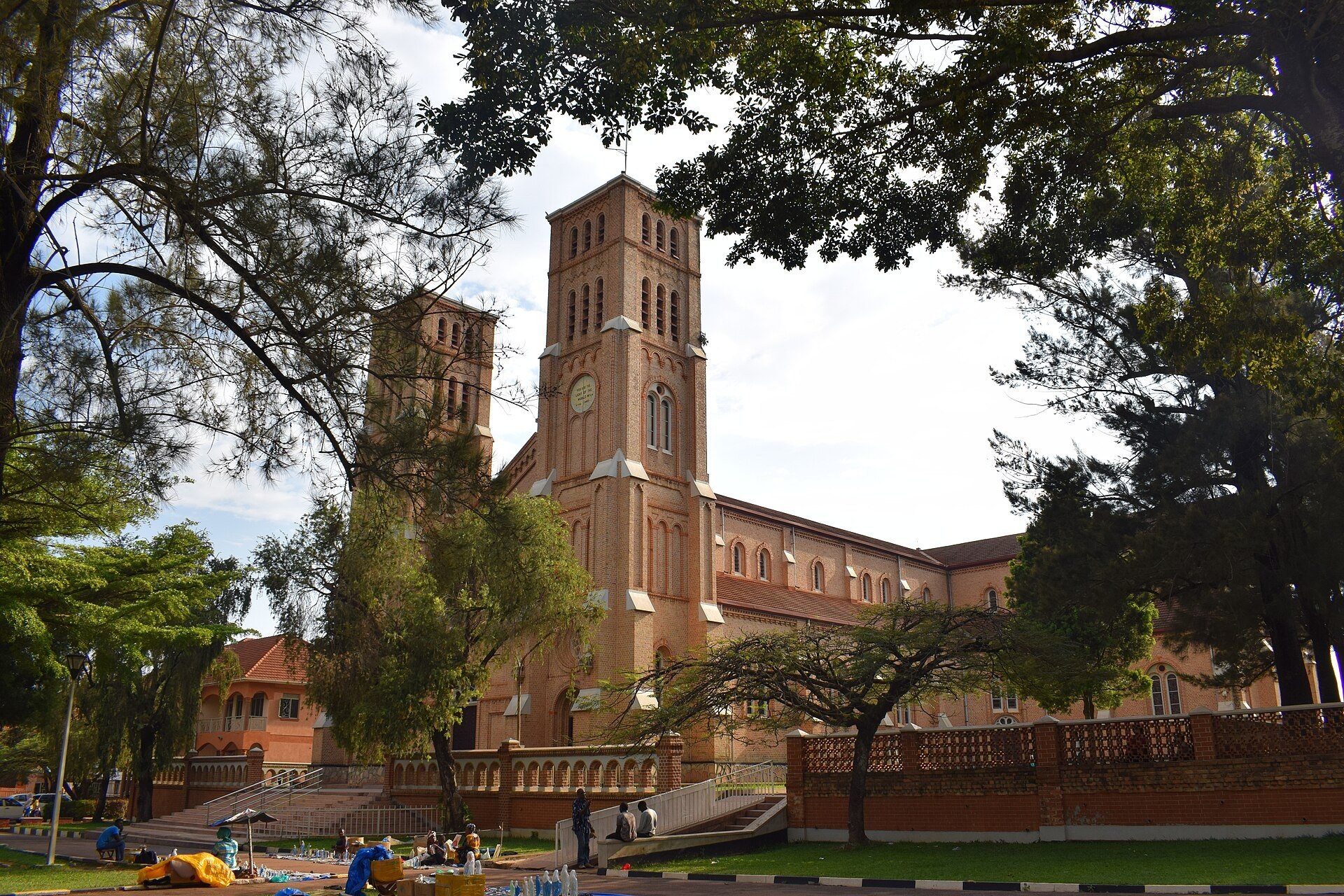 The twin towers of Lubaga Cathedral rising above trees and a garden