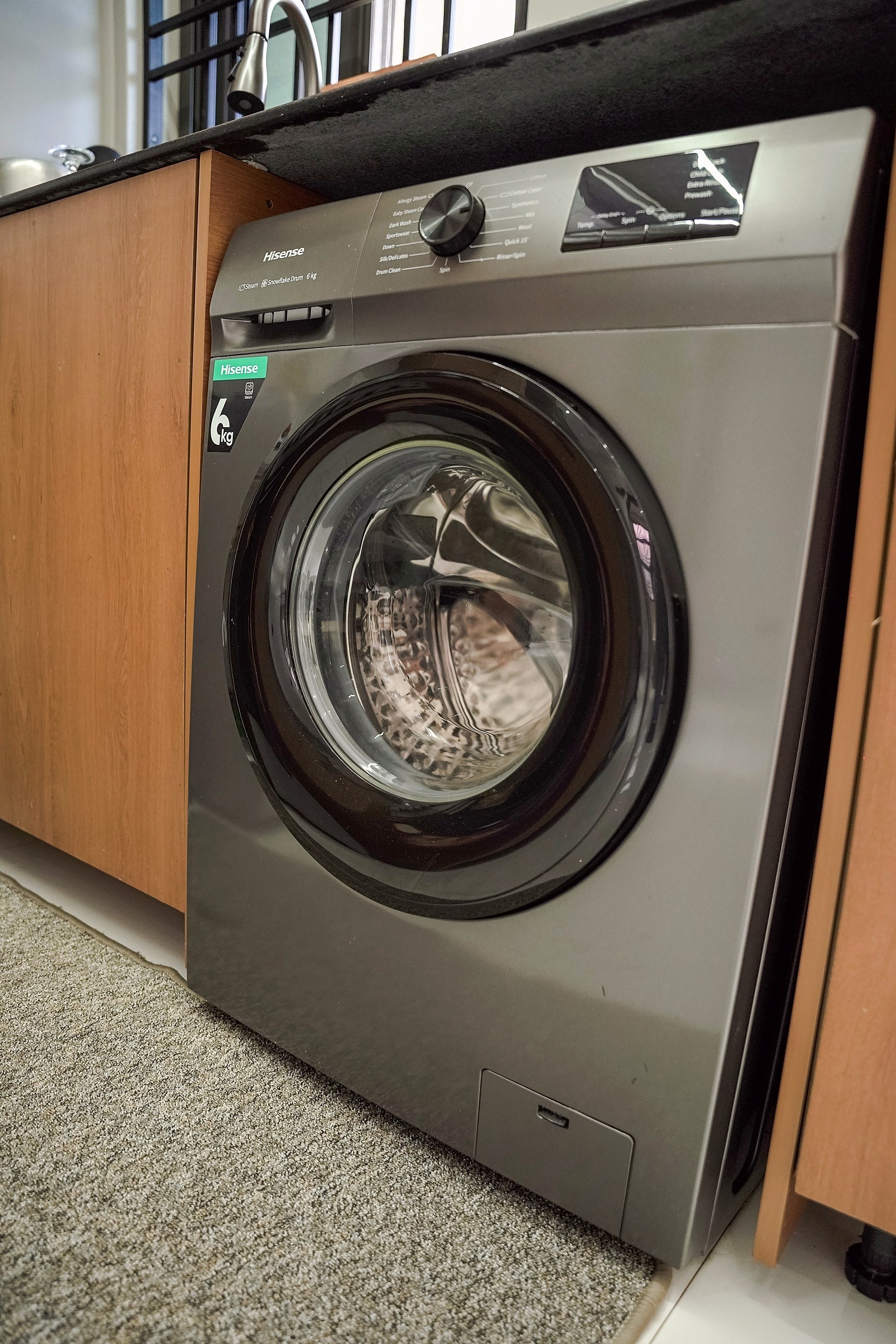 A front loading washing machine set into the cabinets